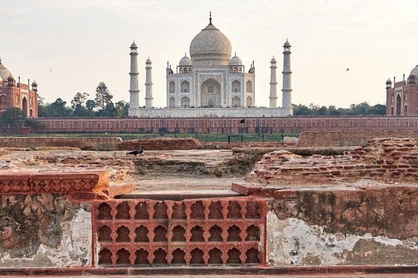The Taj Mahal with its iconic domes and minarets, surrounded by ancient ruins. 2