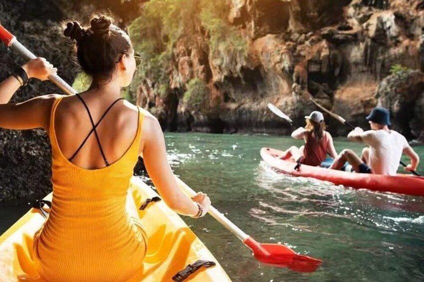 People kayaking on a river surrounded by rocky cliffs. 1