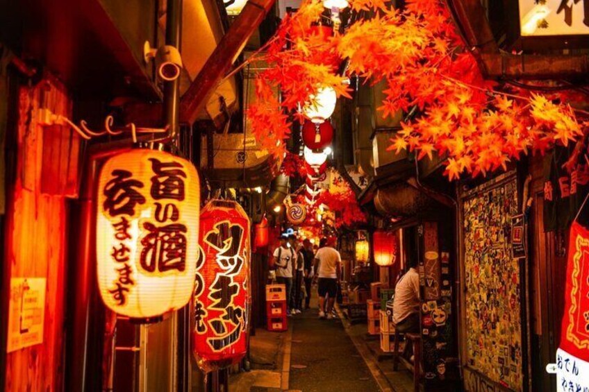 A narrow alley with traditional Japanese lanterns and signs, lined with shops and people walking. 3