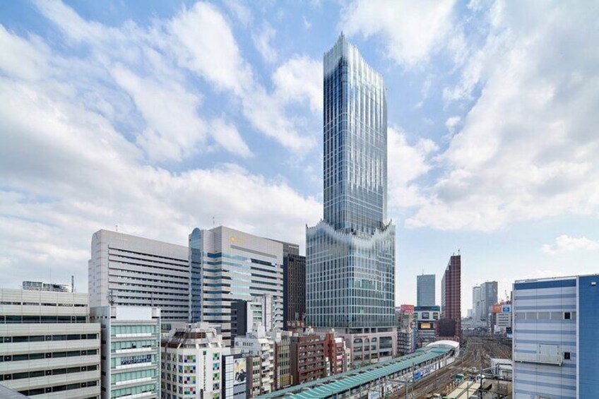 A cityscape with modern skyscrapers, a train track, and a clear sky. 4