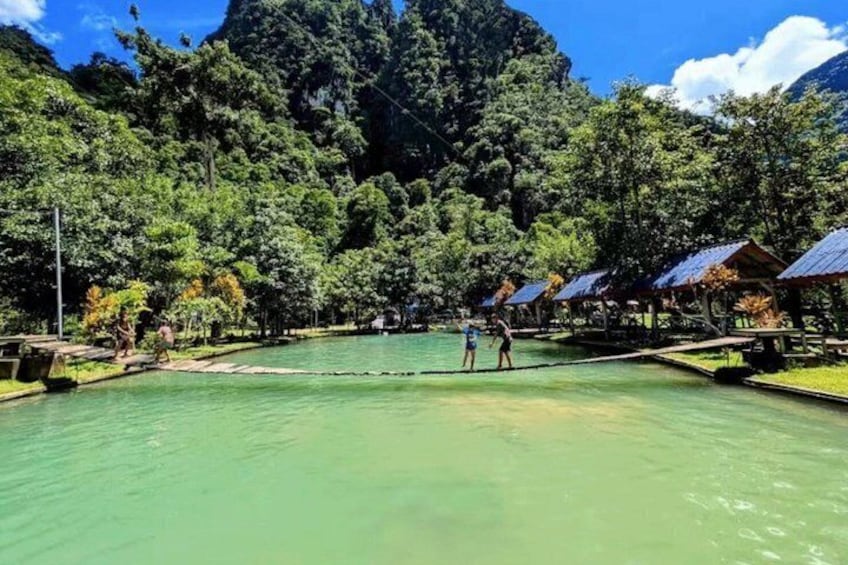 A serene lake surrounded by lush greenery and a mountain backdrop. 1