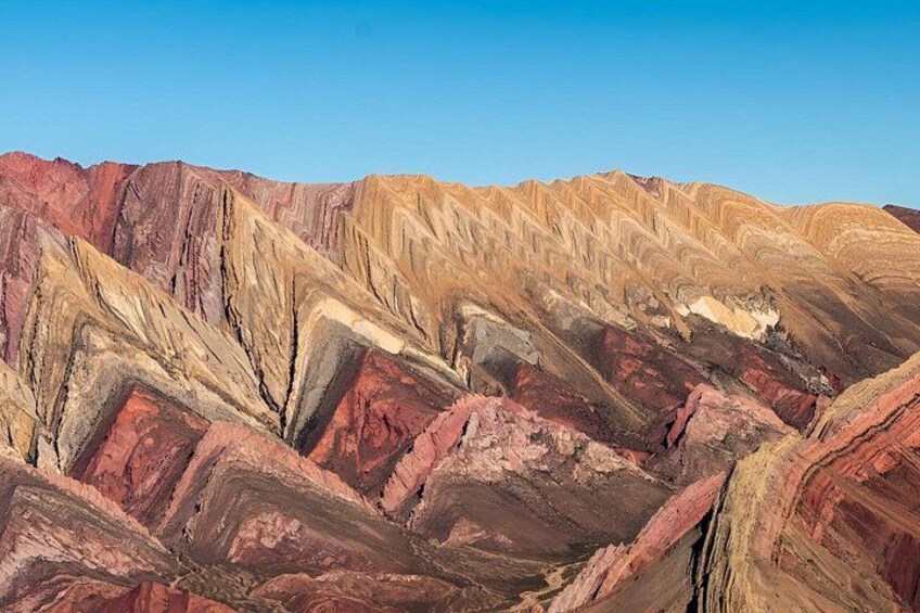 A rugged mountain landscape with layered rock formations. 5