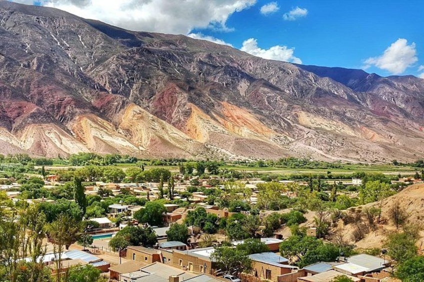 A mountainous landscape with a village in the foreground. 4
