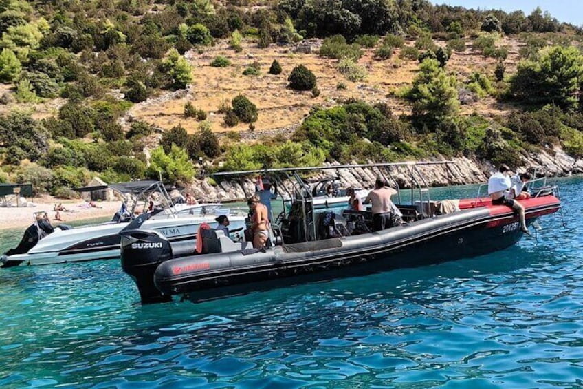 A black and red boat named 'Suzuki' on the water with people on board. 4