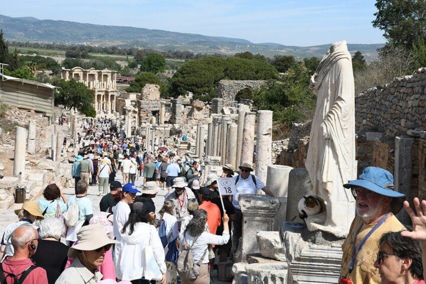 An ancient archaeological site with ruins and a large statue. 2