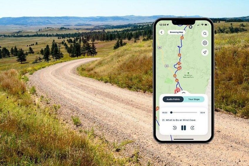 A smartphone displaying a map with a winding dirt road, surrounded by grassy fields and trees. 1