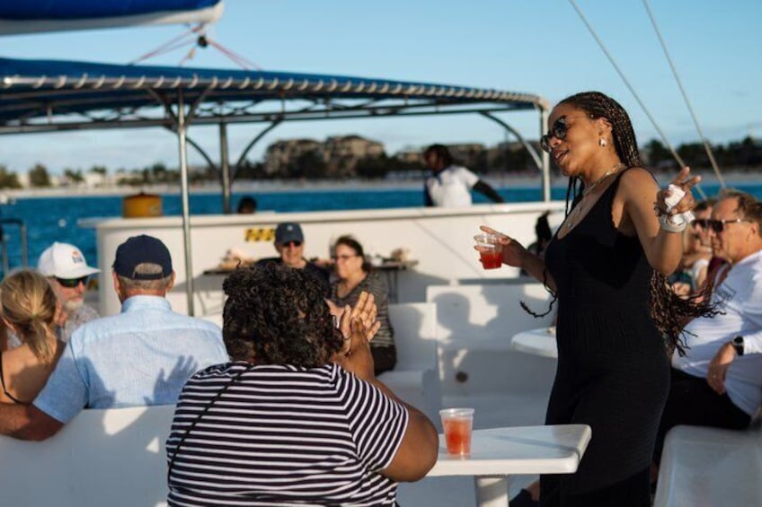 A group of people on a boat with a pool in the background. 5