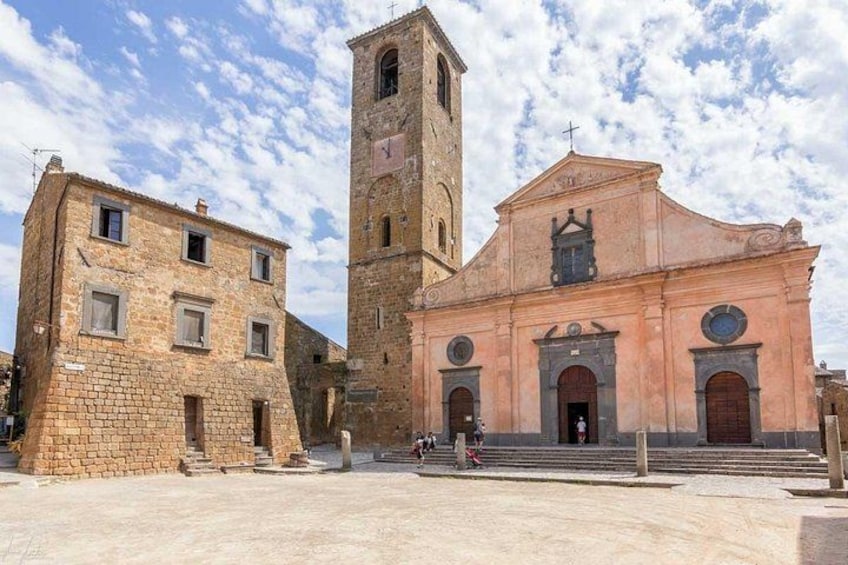 A historic church with a bell tower and a pink facade. 2