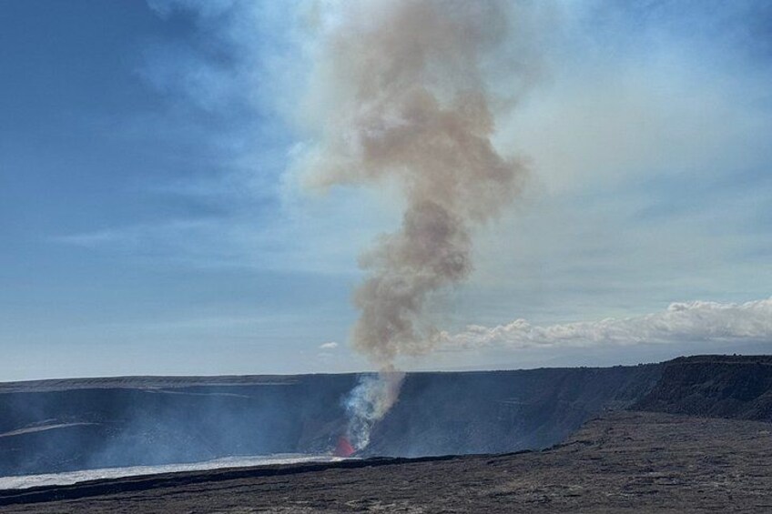 A large open area with a plume of smoke rising from the ground. 4