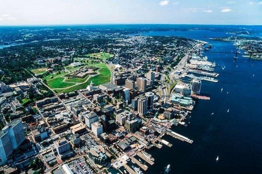 A coastal city with dense urban development, a marina, and a large park. 2