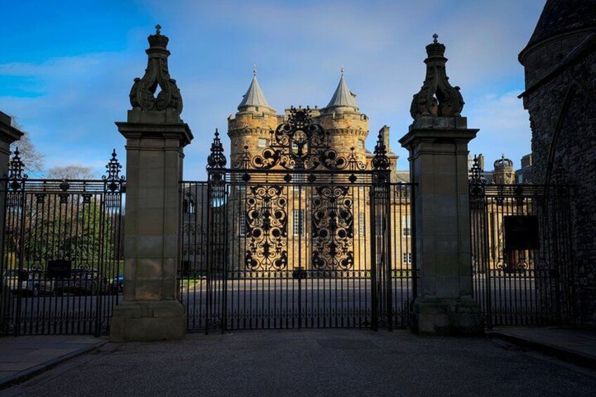 A historic building with ornate iron gates and a stone facade. 1