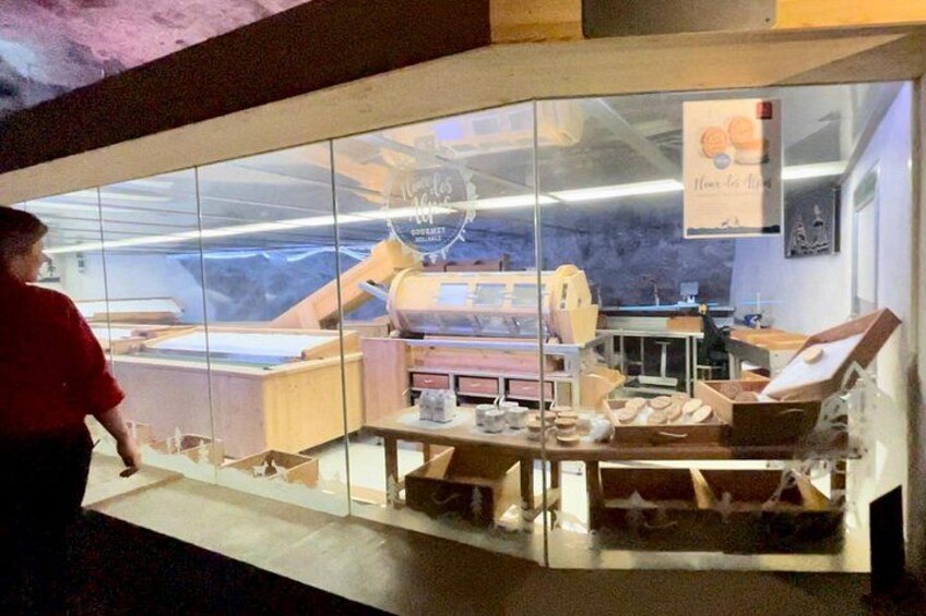 A bakery with a display case and a person in a red shirt. 5