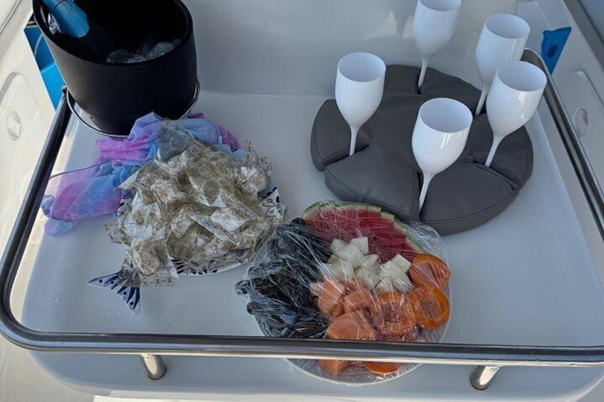 A tray with food items and drinkware on a boat. 5
