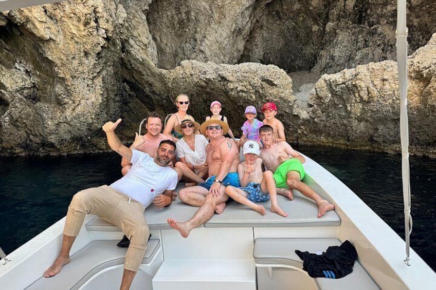 A group of people on a boat near rocky cliffs. 3