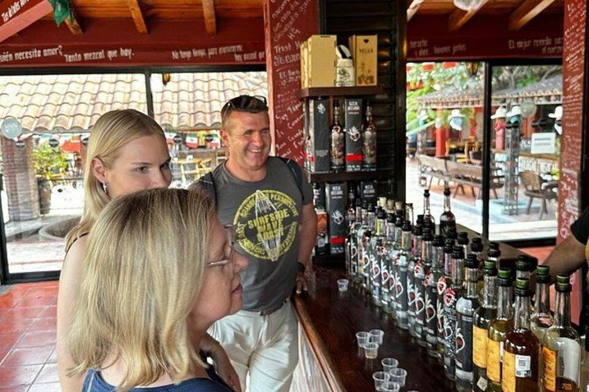 A bar with a variety of bottles and glasses on the counter. 3