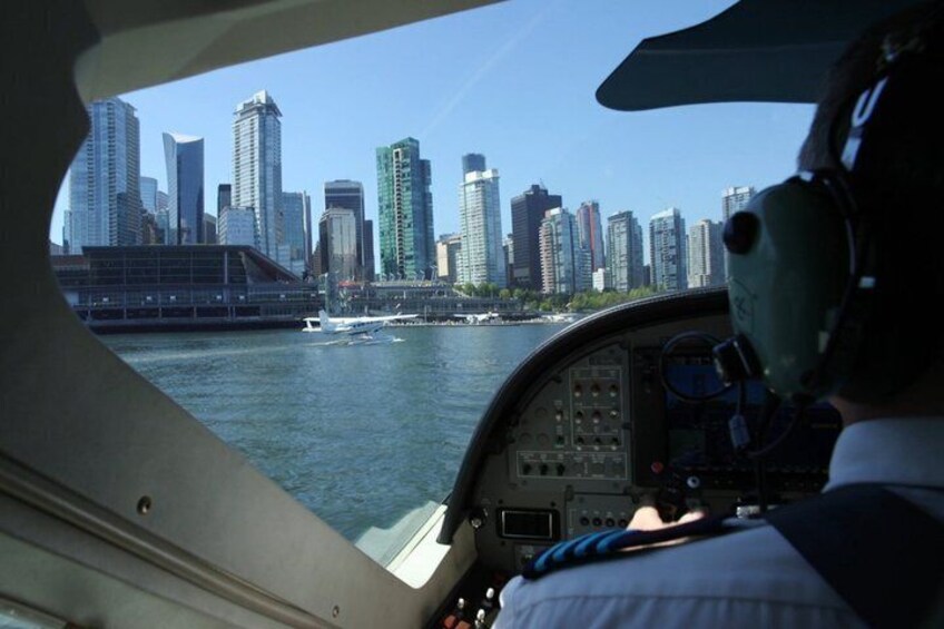 A helicopter cockpit with a city skyline in the background. 5