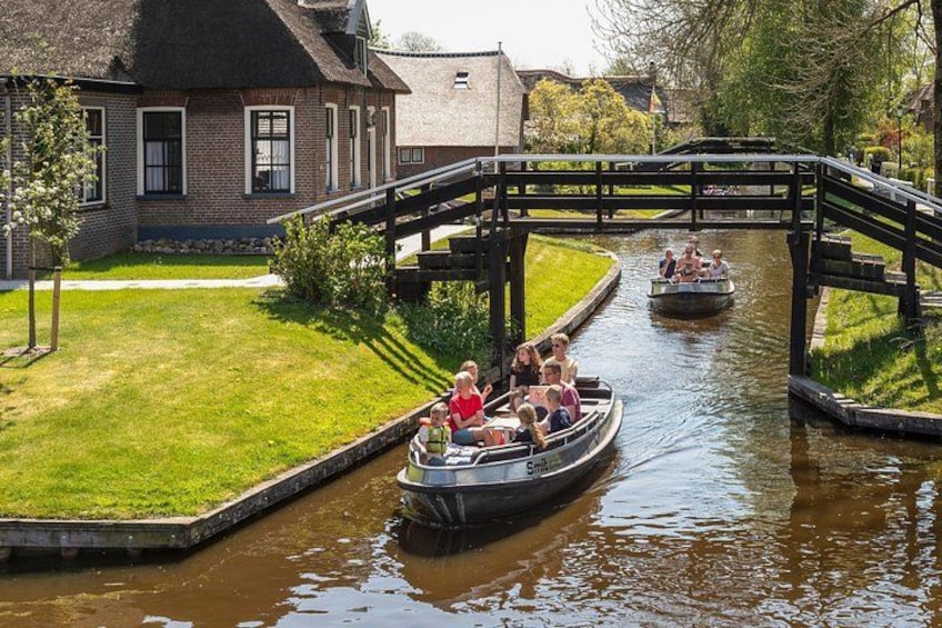 A canal with boats, a bridge, and a building. 1