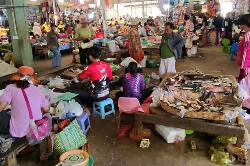 A bustling market with people shopping and vendors selling goods. 5