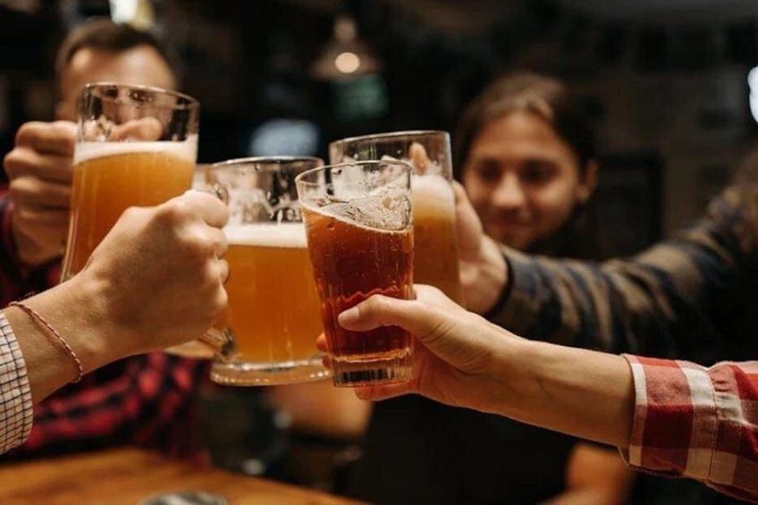 People holding glasses of beer, toasting. 3