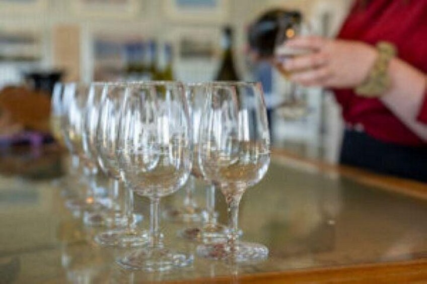 A row of empty wine glasses on a bar counter. 3