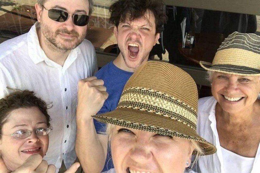 A group of people wearing hats and casual clothing. 5