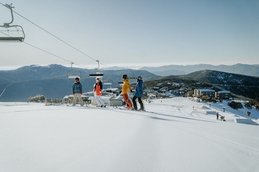 A ski lift, skiers, and a snowy mountain landscape. 3