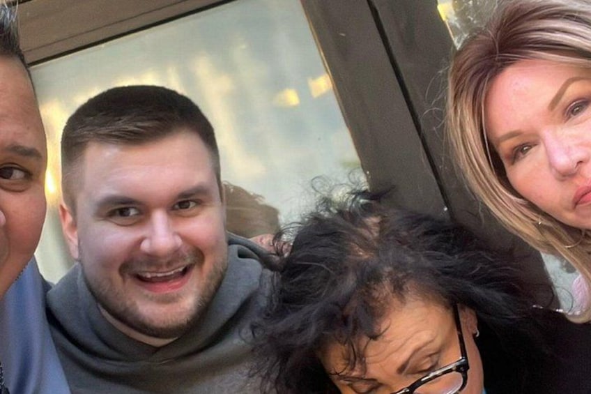 A group of people indoors with a window in the background. 2