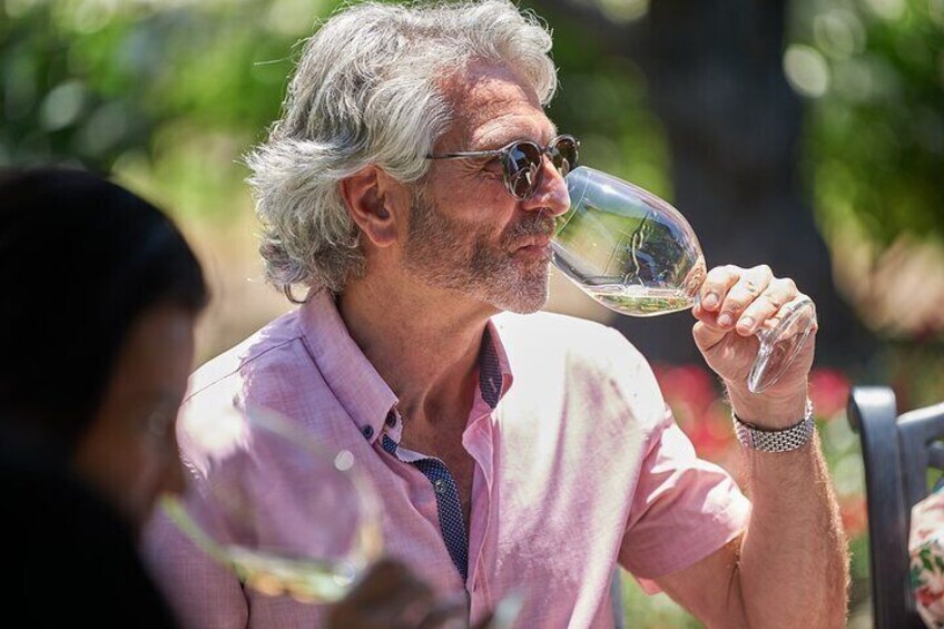 A person holding a wine glass. 5