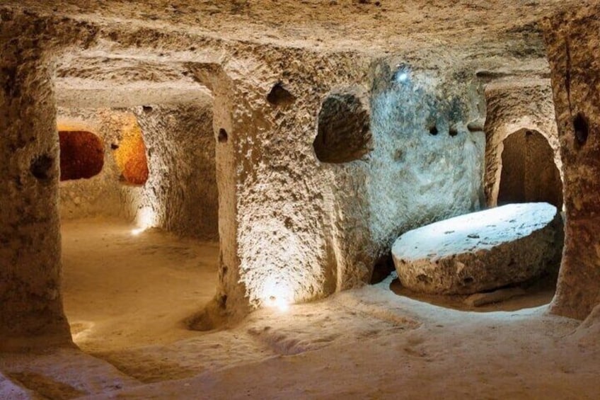 Una cueva antigua con estructuras de piedra y una gran cuenca. 5