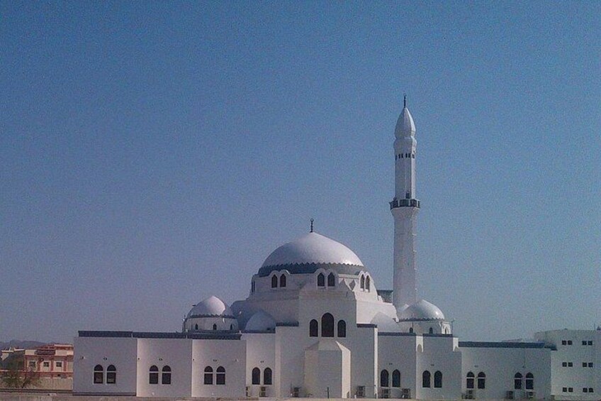 A mosque with a tall minaret and multiple domes. 3