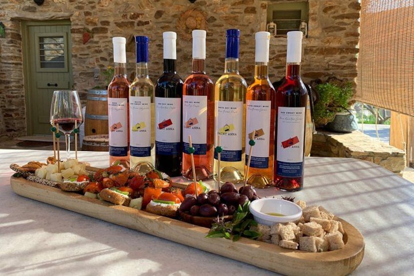 A wine tasting setup with various bottles and a charcuterie board. 2