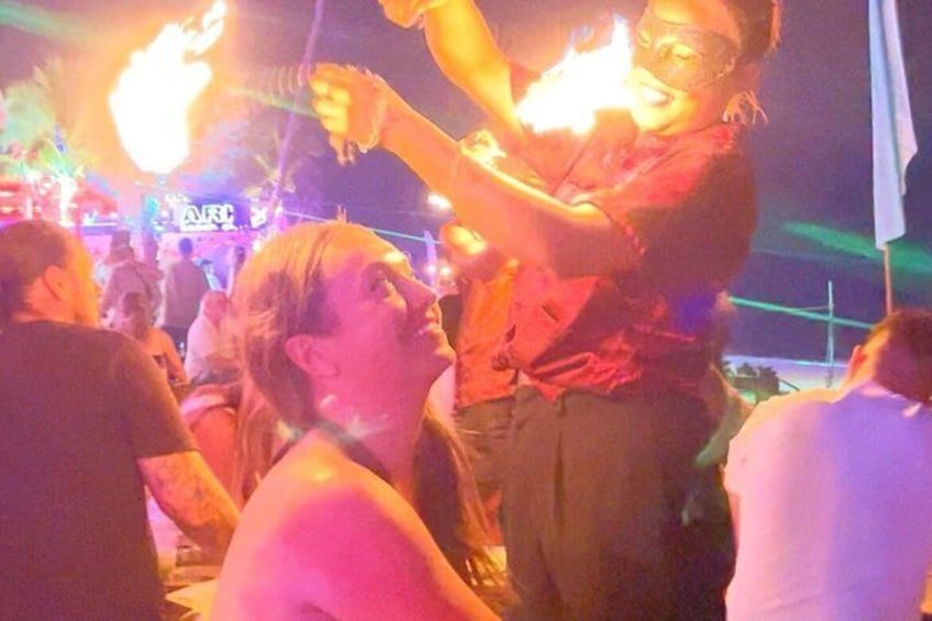 A person holding a torch, with a crowd in the background. 4