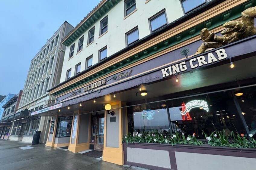 A theater with a sign reading "KING CRAB" and a neon sign above the entrance. 5