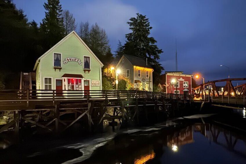A waterfront scene with a green building labeled "STORMHOUSE" and a red building in the background. 3