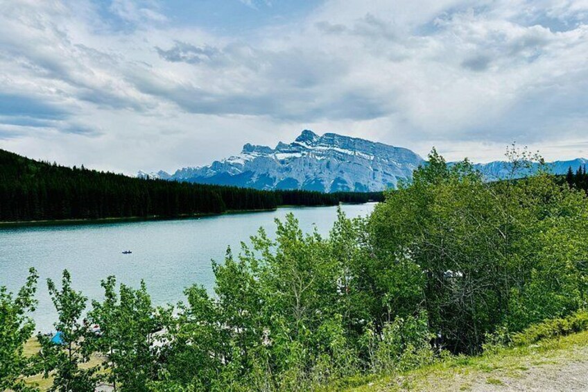 A lake surrounded by trees and mountains. 2