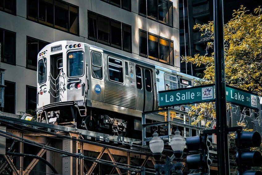 A silver train on elevated tracks, crossing N La Salle St and W Lake St. 3