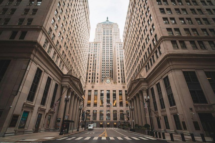 A street view with tall buildings, a crosswalk, and a traffic light. 3
