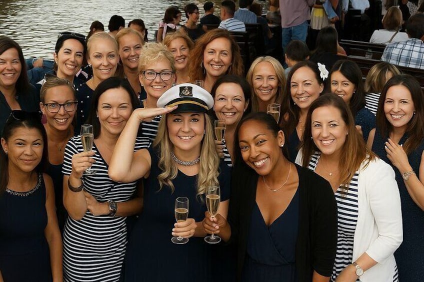 A group of people at a lakeside gathering, some holding drinks. 5