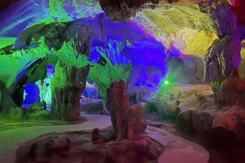 A cave with colorful lighting and stalactites. 2