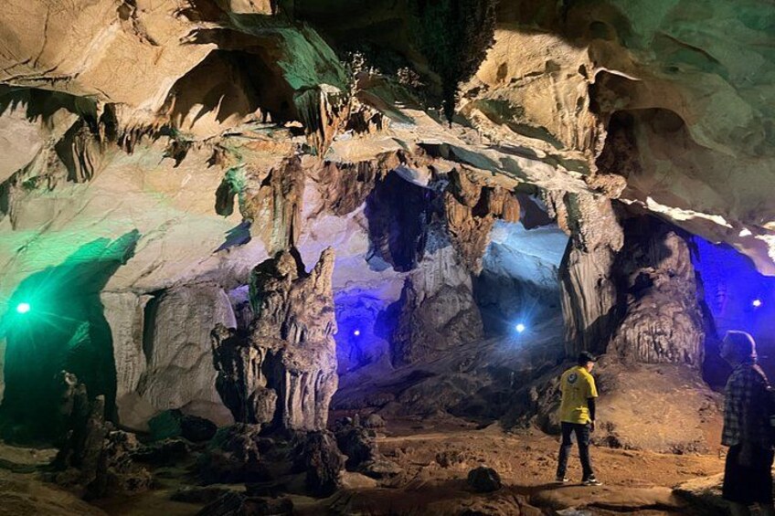 A cave with stalactites and stalagmites, illuminated by spotlights. 3
