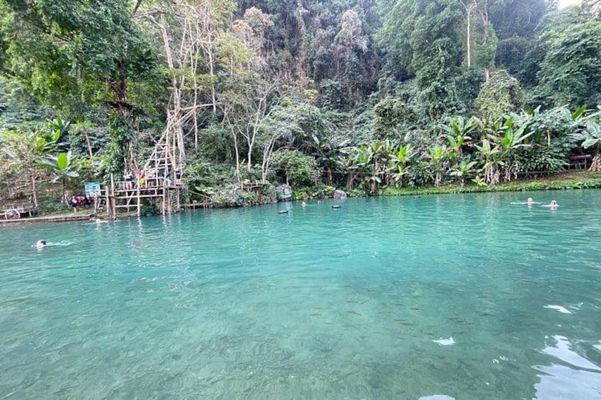 A clear turquoise lake surrounded by dense tropical vegetation. 2