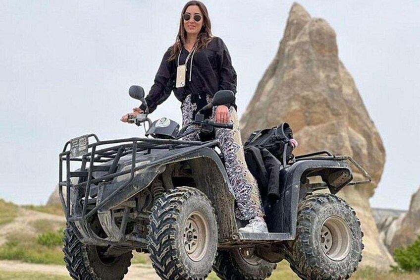 A person on an ATV in a rocky outdoor setting. 3