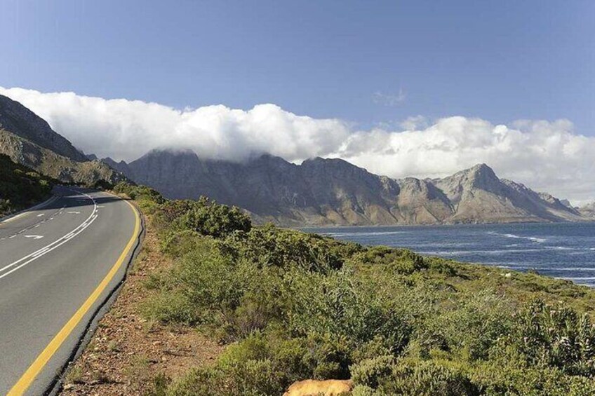 A winding coastal road with mountains in the background. 4