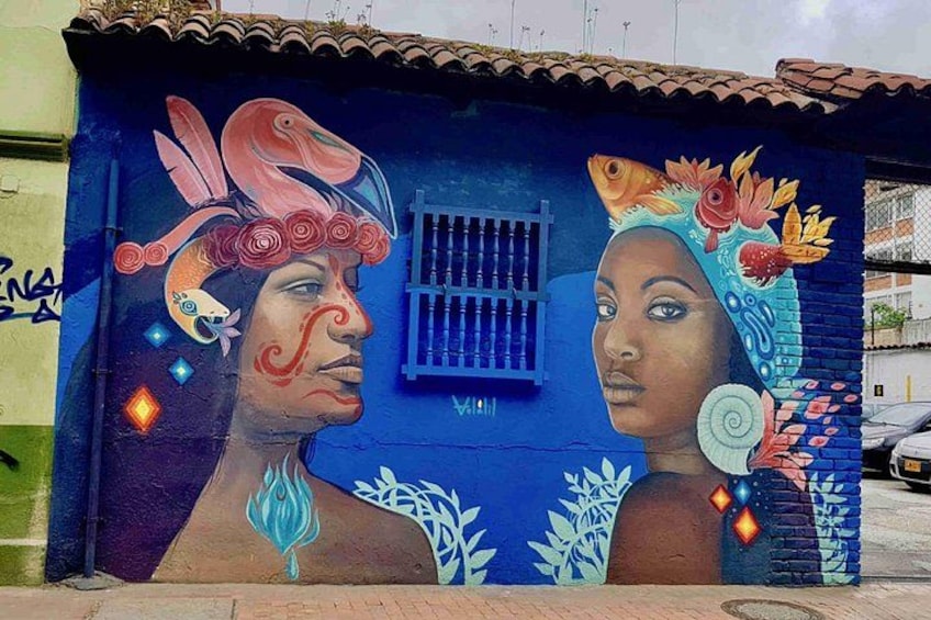 A mural with a person wearing a headdress and a woman with a headpiece. 5