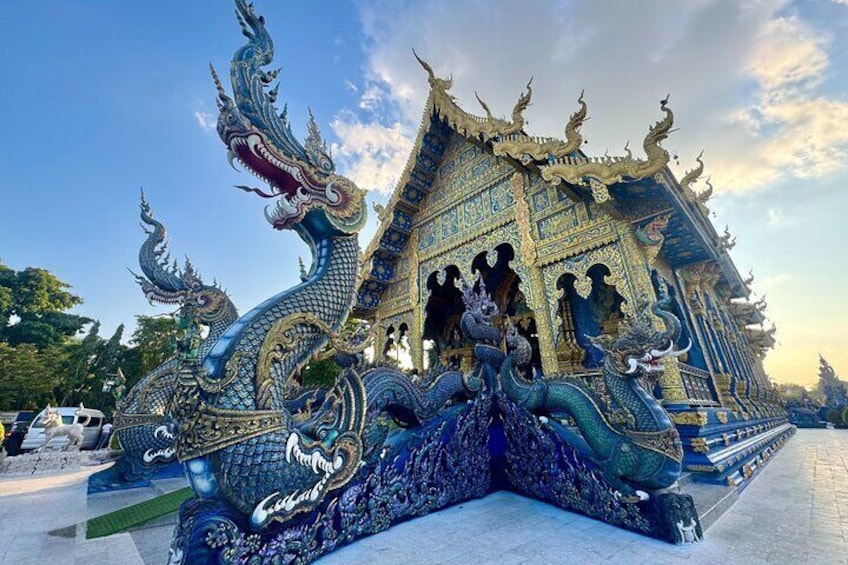 A temple with a dragon sculpture in front. 1