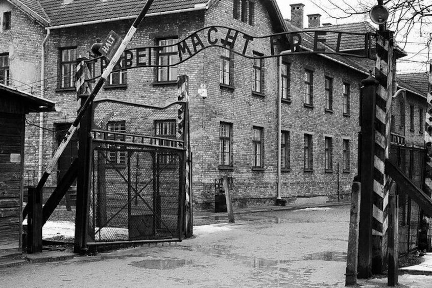 Een historisch gebouw met een bord waarop 'MAKTHREIFELD' staat en een poort met een metalen hek. 1