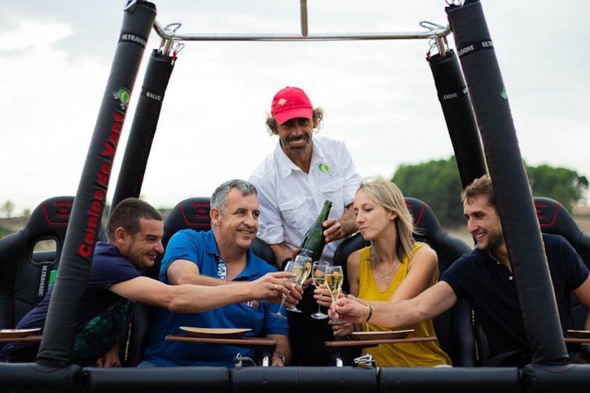 A group of people toasting with champagne in an inflatable boat. 1
