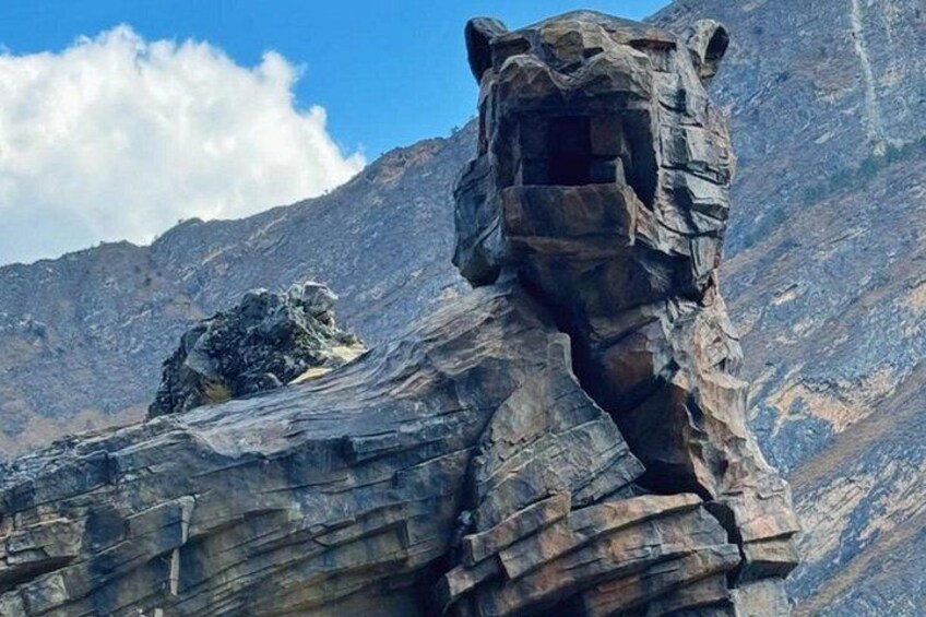 A rock formation resembling a bear's head in a mountainous area. 5
