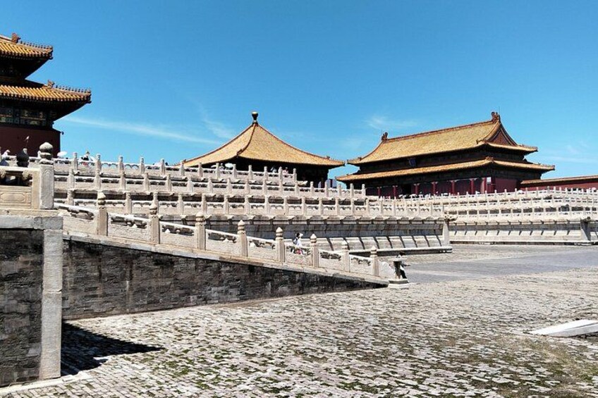 A traditional Chinese architectural structure with a stone bridge and tiled roof. 3