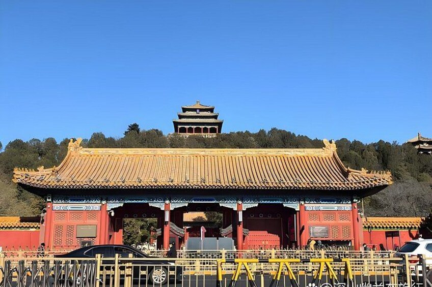 A traditional Chinese gate with a red and yellow roof, surrounded by a fence. 4